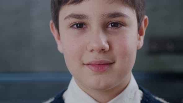 Closeup Portrait of 12-13 Years Old Boy Looking at Camera at Home