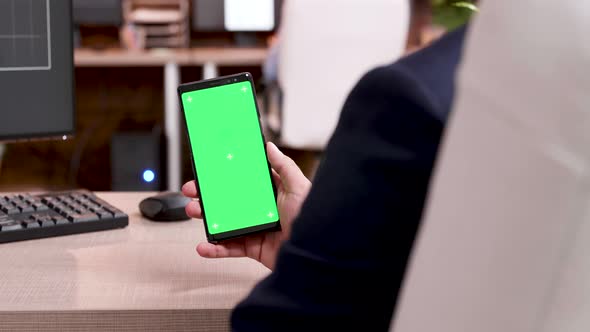 Close Up of Businessman Holding Mobile Phone with Green Screen