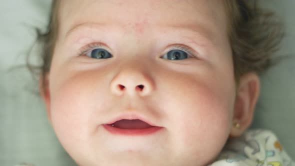 Closeup of Beautiful Baby Smiling at Camera in Slow Motion