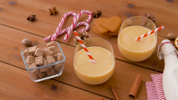 Glasses of Eggnog, Ingredients and Spices on Wood