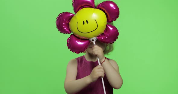 Girl Holds Balloon in the Form of Flower. Happy Four Years Old Girl. Chroma Key