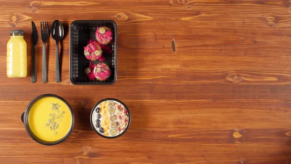 Food Delivery Top View Take Away Meals in Disposable Containers on Wooden Table