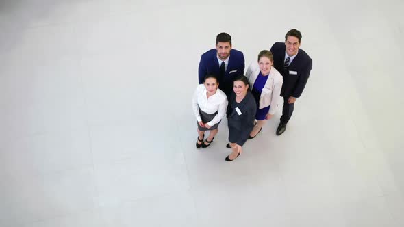 Smiling businesspeople waving hands in office