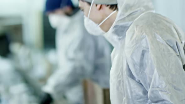 Male Worker Inspecting Waste on Conveyor Belt