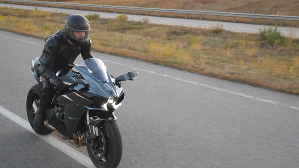 Top View of Motorcyclist Racing His Motorcycle on Country Road