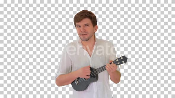 Young man playing ukulele and signing while walking, Alpha Channel