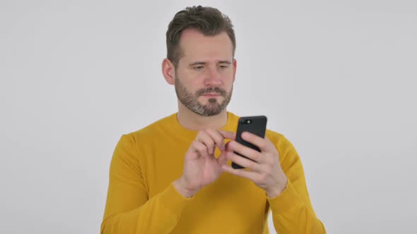 Portrait of Middle Aged Man Celebrating on Smartphone