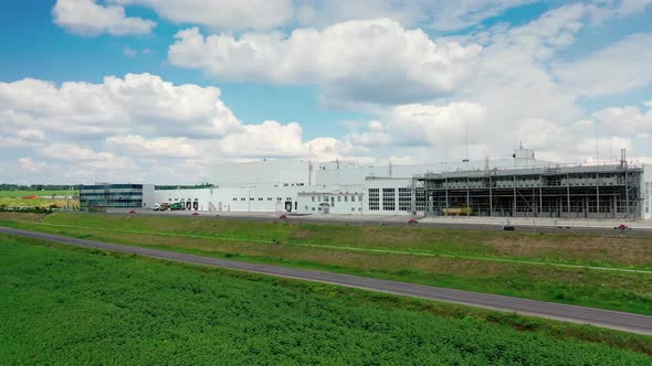 Contemporary industrial factory. Exterior of a large modern production plant in the countryside.