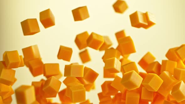 Super Slow Motion Shot of Flying Cheddar Cheese Cubes at 1000 Fps