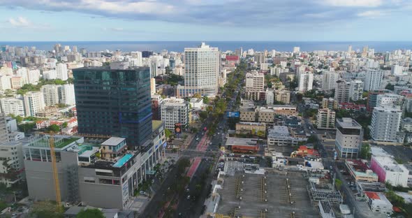 Drone aerial flying towards tall skyscrapers in city center center to Santo Domingo Dominican republ