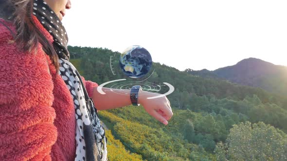 Young woman uses a hologram for explore the map traveling in wildlife