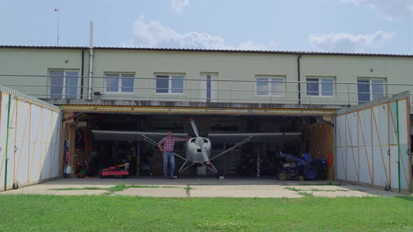 Aviator Standing Airplane Hangar Countryside