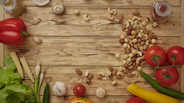 Faceless Person Moving Nuts on Wooden Table