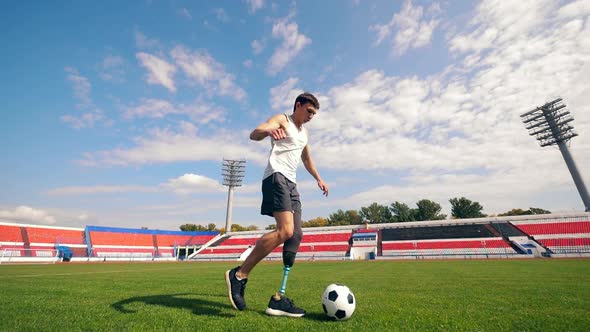 Disabled Footballer Is Running with a Ball in Slow Motion