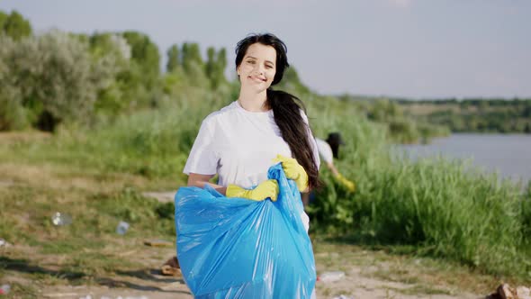 Beautiful Volunteer Lady with a Big Blue Plastic