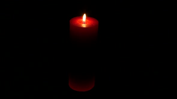 Candle Flame Isolated on Black. Red Candle. Close Up