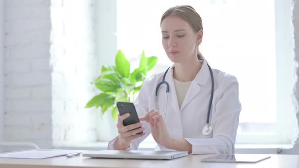 Lady Doctor Talking on Phone in Clinic