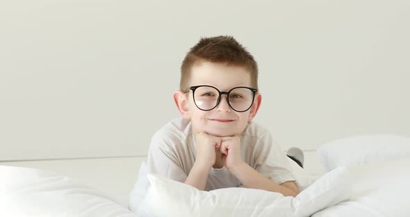 Portrait child boy With Glasses Looking at Camera. Laughs Happily toothless kid with Glasses Looking