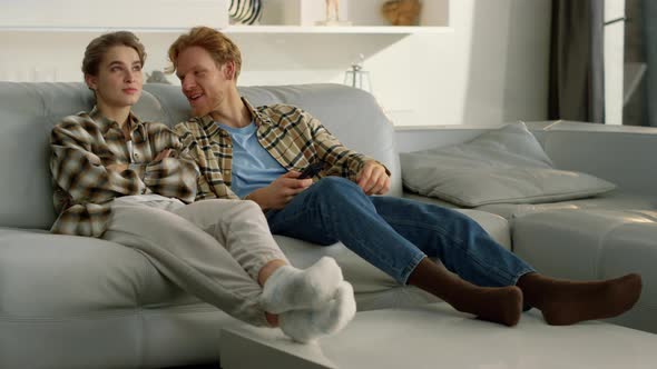 Two Friends Enjoying Television Show at Home