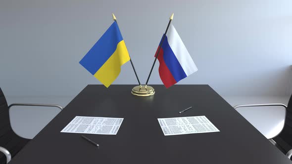 Flags of Ukraine and Russia on the Table