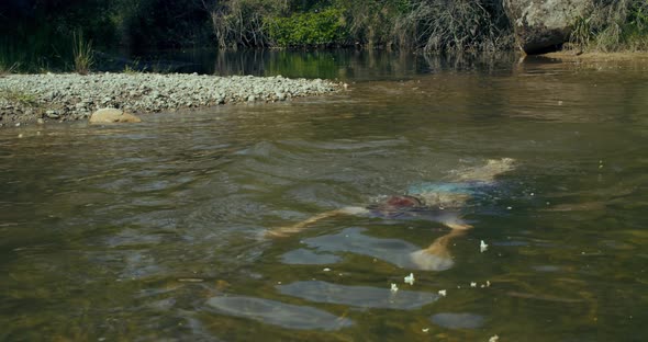 Child Boy Dive and Swim in Clean Fresh Water of Mountain River at Vacations