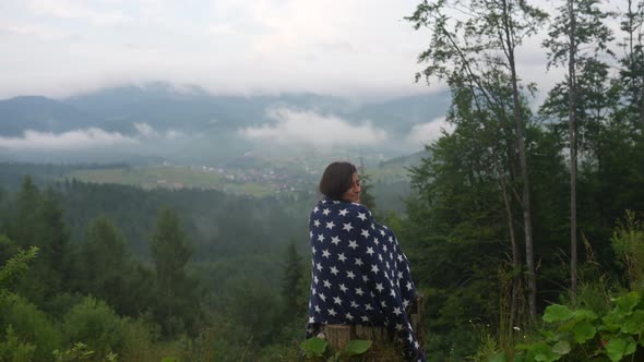 Woman on Top of a Hill Against the Background of a Valley