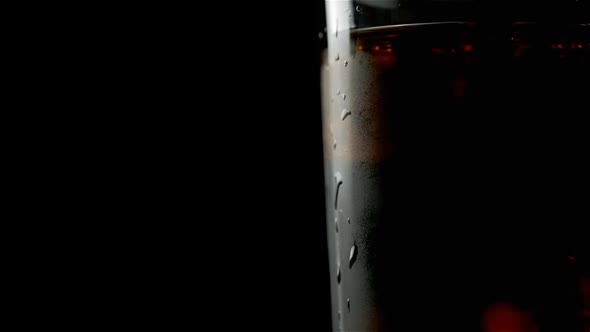 A Glass Of Soda And Whiskey In Which Three Ice Cubes Float