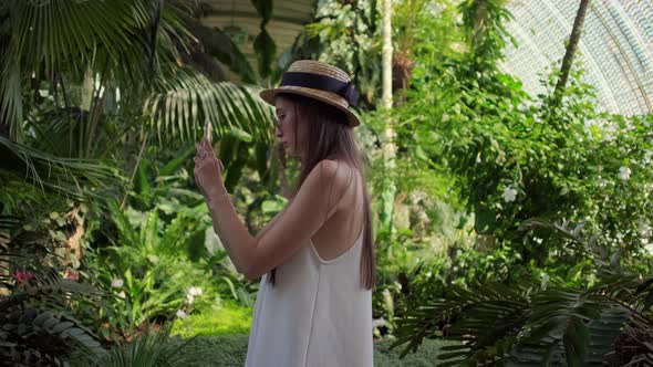 Girl Taking Mobile Pictures in the Greenhouse of Lednice Czechia