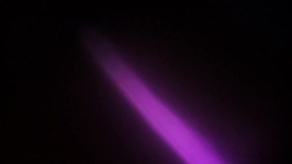 Purple light leak overlays footage .Black background