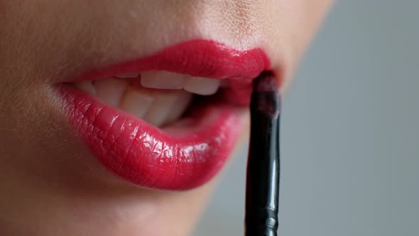 Macro Shoot  Woman Paints Her Lips With Lipstick