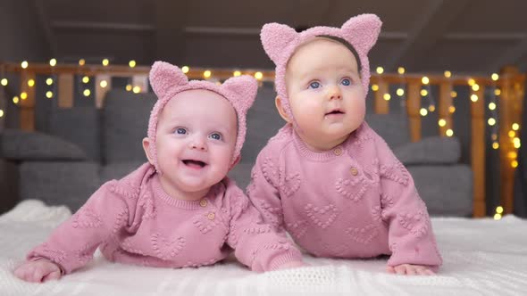 Two Baby Girls Smiling And Playing Together. Happy Infancy Concept.