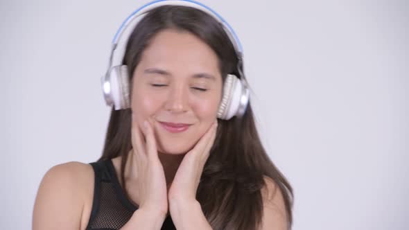 Face of Young Happy Multi-ethnic Woman Listening To Music Ready for Gym