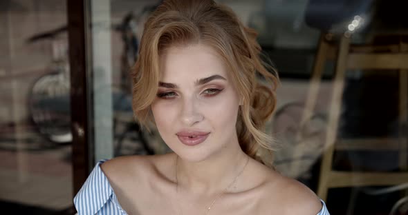 Sexy Girl Sitting In A Cafe On The Summer Terrace