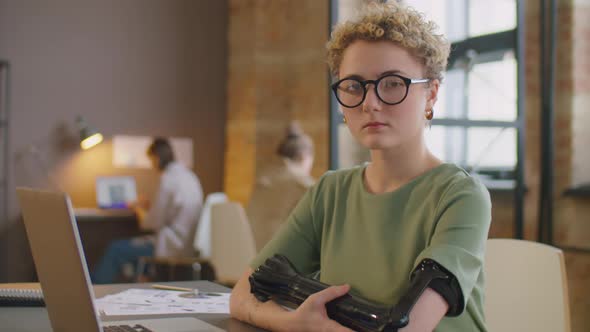 Portrait of Businesswoman with Prosthetic Arm in Office