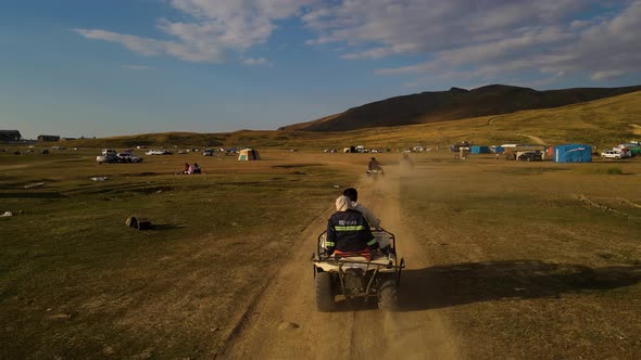 Aerial View From Behind ATVs by Lake and Mountain