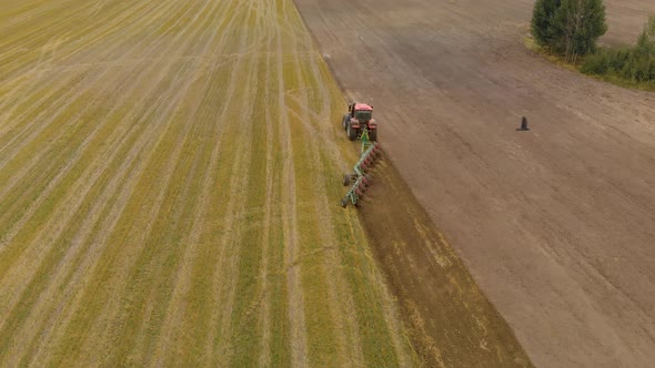 Tractor Cultivates Farmland with Multibody Trailer Plow