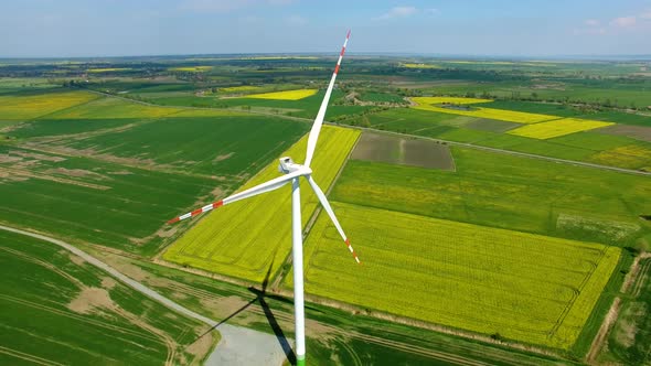 The wind power stations on the spring field, view from a drone