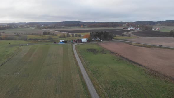 Rural Road Along Farm Field Aerial Descending