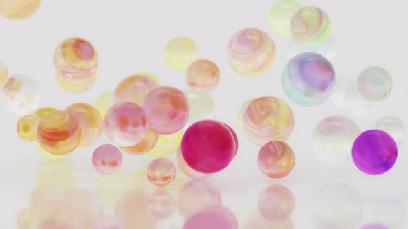 Gradient balls falling on a white background