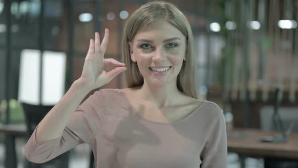 Portrait Shoot of Young Woman Showing OK Sign