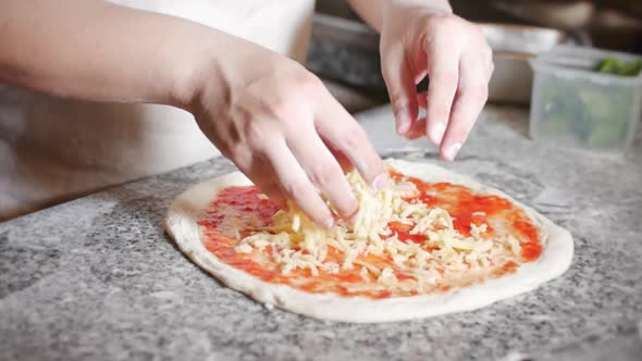 Italian Chef Prepares Real Italian Pizza, Sprinkles Pizza with Parmesan Cheese.