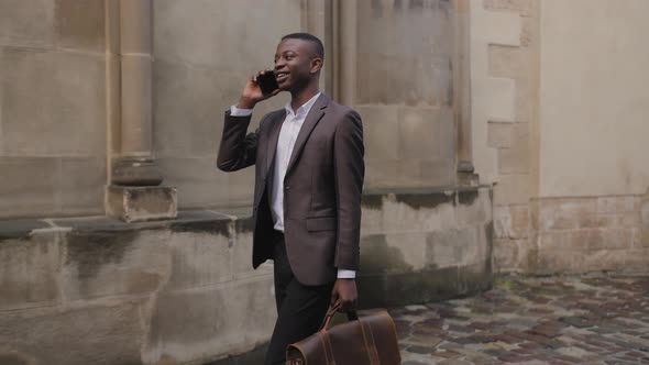 Afro American Man in Suit Talking on Mobile on Street