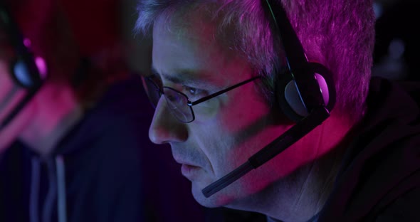 Caucasian man typing on computer keyboard in a creative office