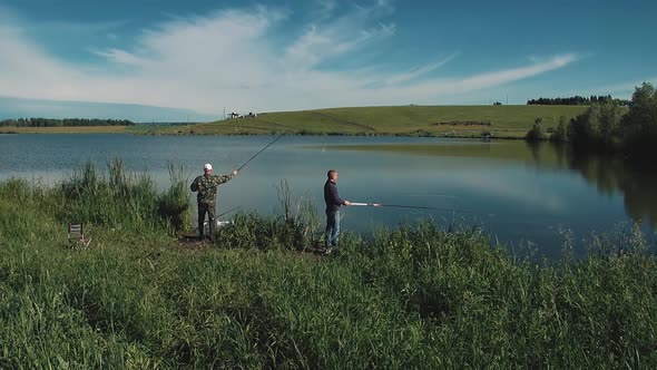 Two Young Guys are Fishing on Lake