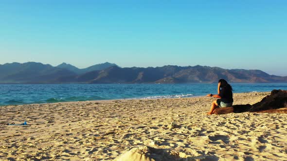 Sexy smiling lady relaxing enjoying life on beach on paradise white sand and blue 4K background