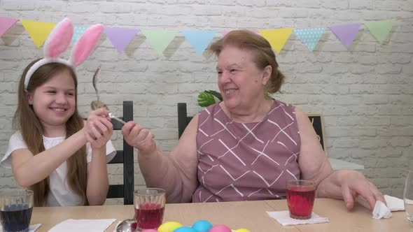 Grandmother Granddaughter Fight with Spoons While Preparing for Easter