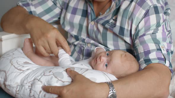 Grandfather Holding Newborn Baby Girl