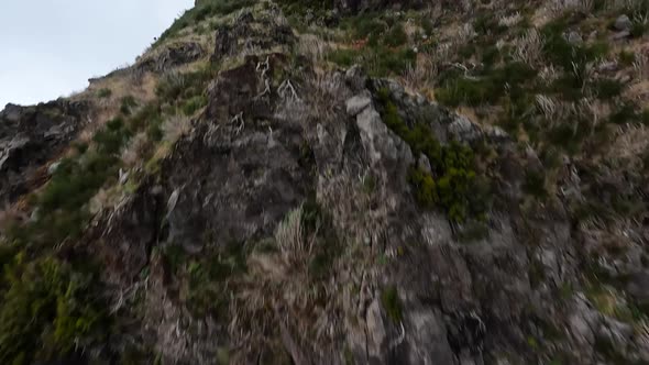 Mountain Surfing Flying and Diving Along High Cliffs and Rocks Into a Valley