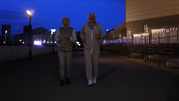 Elderly People Jogging in Evening