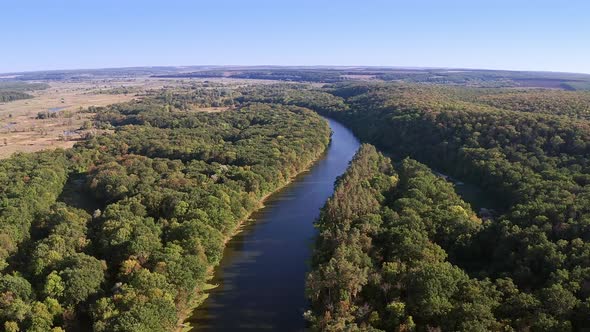 Aerial View of Flying Over the Forest and River